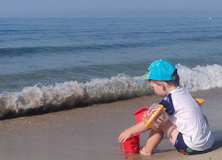 Rosie playing while the wave breaks