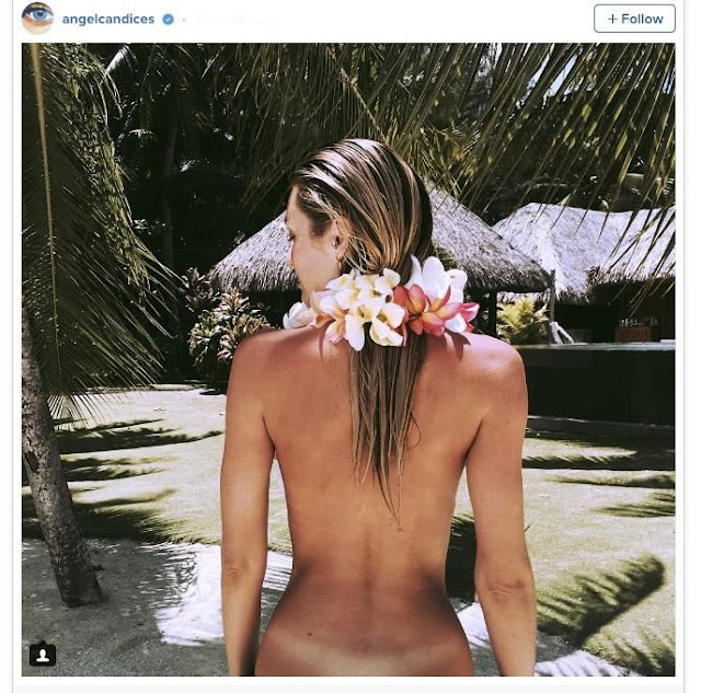 Candice Swanepoel showed off her tan lines while on holiday.