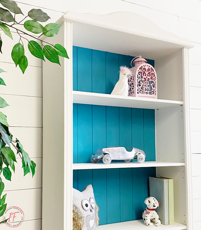 A small bookcase makeover for a baby nursery with mid-century modern style by replacing bun feet with vintage tapered wooden feet for a new look.