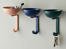 wall hooks on pink, blueand green — with a small bowl on the top of each hook