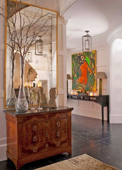 beautiful foyer room with gold and modern art vignette