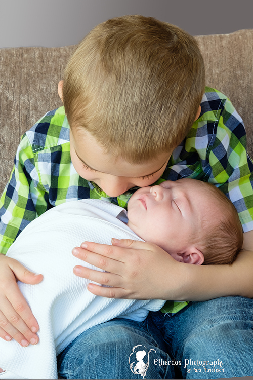 Professional portrait of a newborn baby and her family