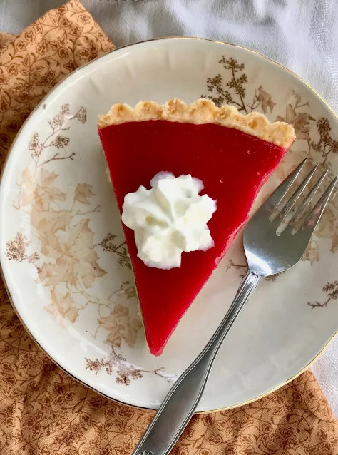 Slice of cranberry curd tart on a serving plate.