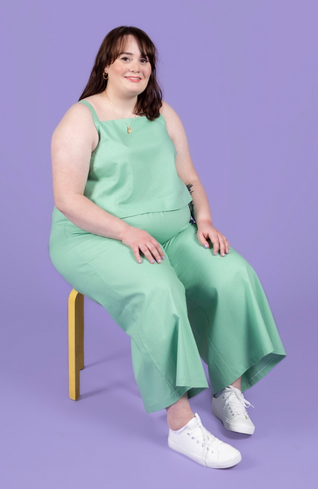 Plus size model wearing matching top and trouser co-ord in a pastel green. The set was made using the Esti co-ord sewing pattern