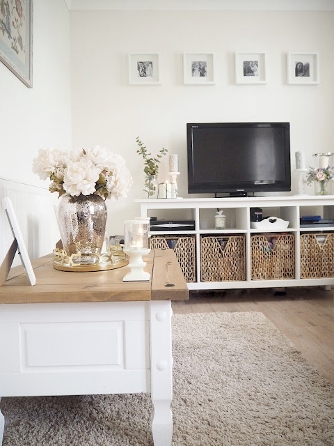 Before and after pictures showing how we transformed our dingy, small brightly-coloured lounge into a bright and airy living room using neutral coloured paint and accessories