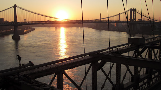 The sun rises over the East River.