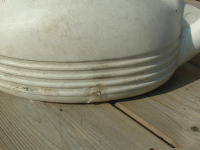 Close up of a mended crack in a plastic watering can