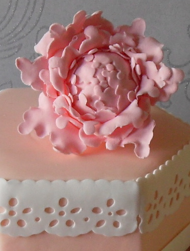 Pretty pink peony cake with blush pink fondant and white Broderie Anglaise