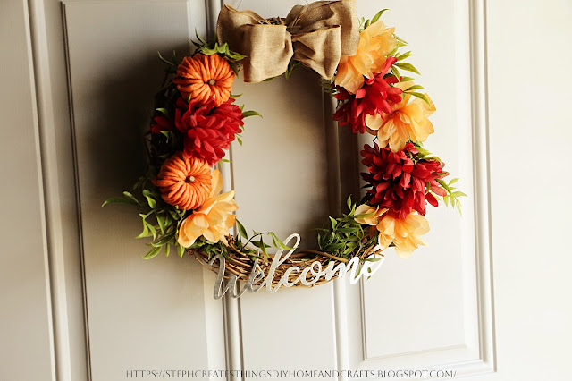 grapevine wreath with pumpkins, floral and foliage