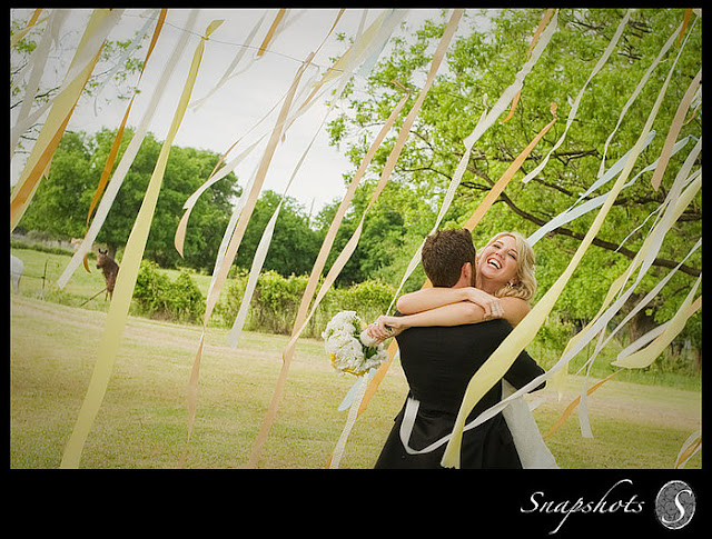 ribbons acted as the backdrop for their wedding ceremony
