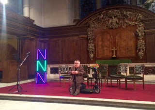 Simon Minty speaking to an unseen audience in the St James's church in Piccadilly