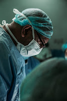 Surgeon performing blepharoplasty operation Photo by JC Gellidon on Unsplash