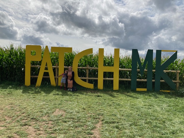 a group of people standing in front of a sign