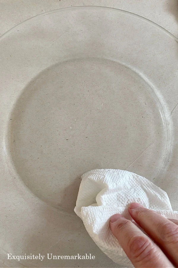 Washing A Glass Plate with a paper towel