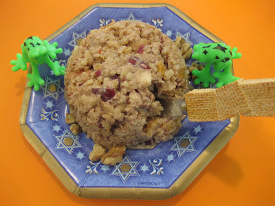 A paper plate with Jewish stars on it with a large ball of charoset sitting gin the middle