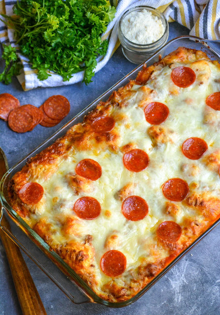 Bubble Up Pizza Casserole in a casserole on a gray background.