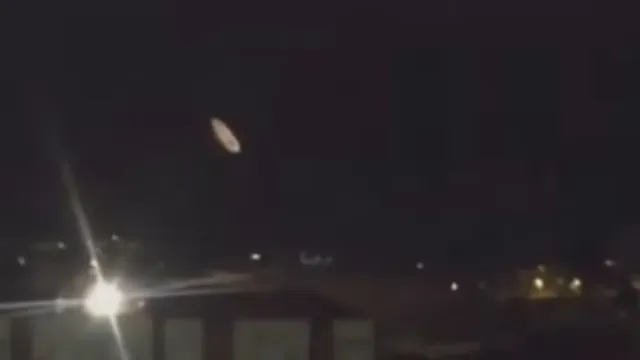 Night time sky saw an elongated White UFO which could have been filmed over the UK.