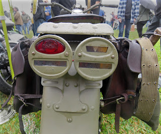 Regular and hooded tail lights on back of military motorcycle.