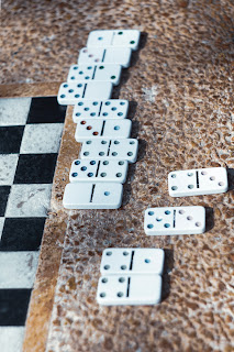 Chess board with dominoes next to it