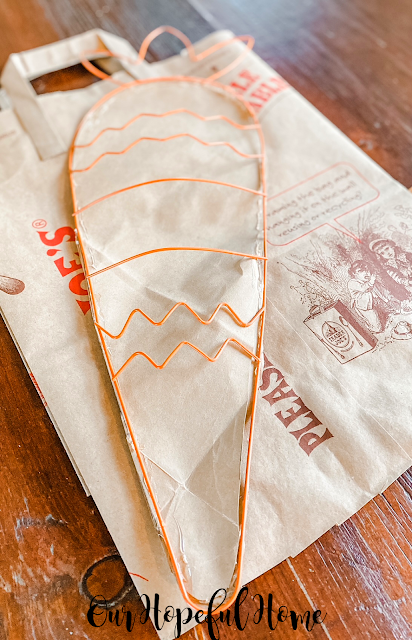 orange wire carrot form on paper bag