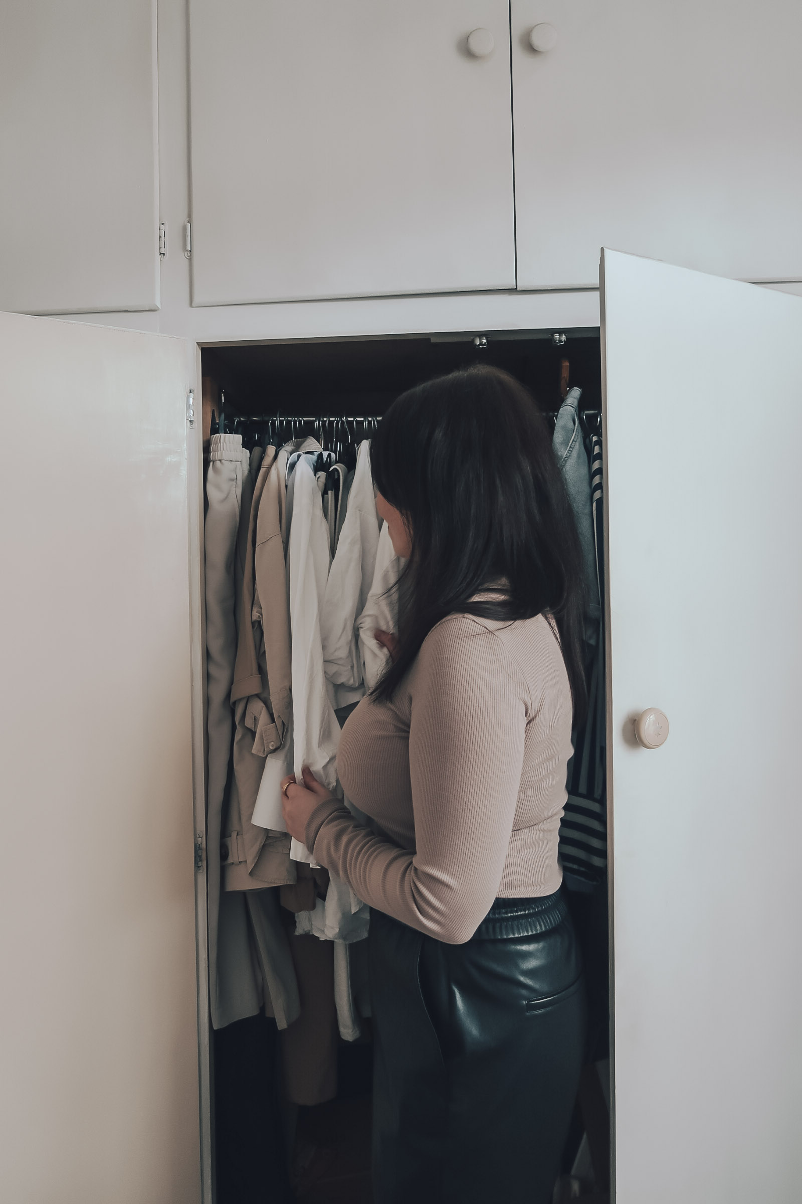 A woman decluttering her wardrobe.