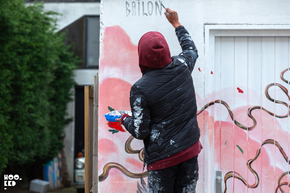 Brazilian street artist Mateus Bailon pictured at work on a mural in Ostend, Belgium