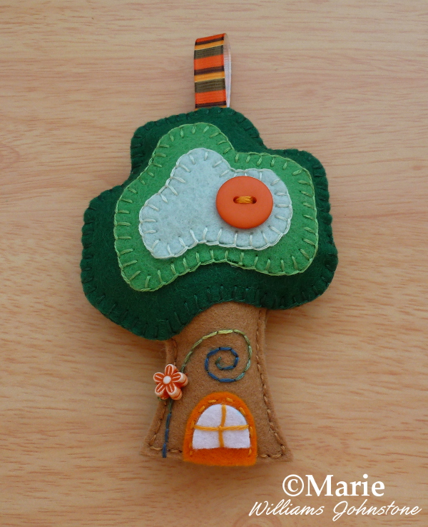 Green and brown felt tree house ornament decorative stitching