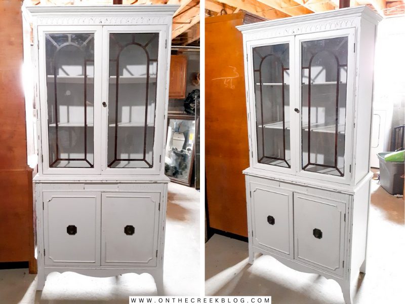 A creatively transformed hutch from Habitat For Humanity ReStore, repainted by Tiff in chippy white with red accents, showcasing a distressed finish and a blend of old and new charm. | on the creek blog // www.onthecreekblog.com