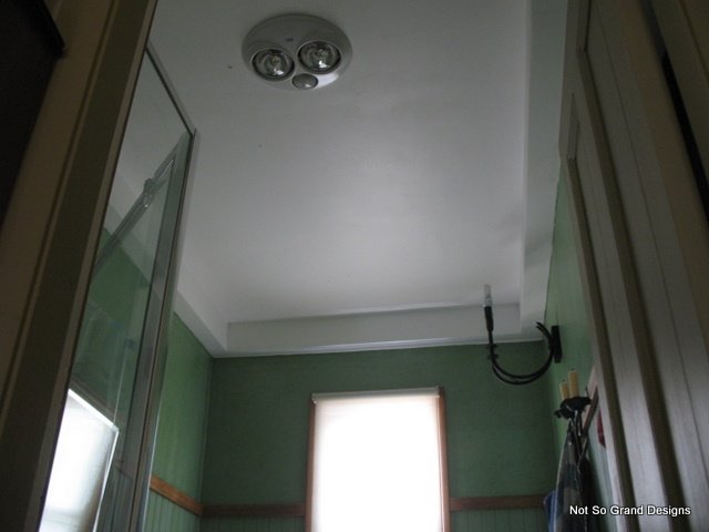  The ceiling light, wall light bracket, candles on little cupboard and window, from doorway.