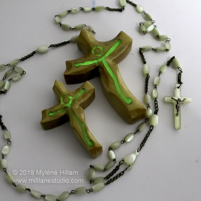 Wooden crosses with glow in the dark resin representing Jesus.