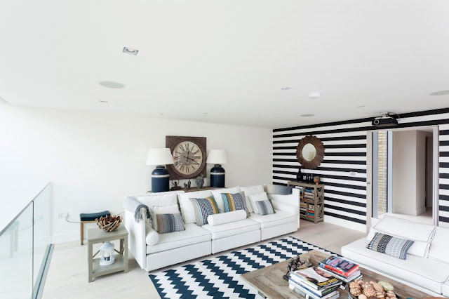 Picture of modern living room with white furniture and blue carpet