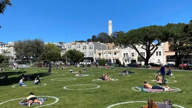People practice social distancing at Washington square park in San Francisco