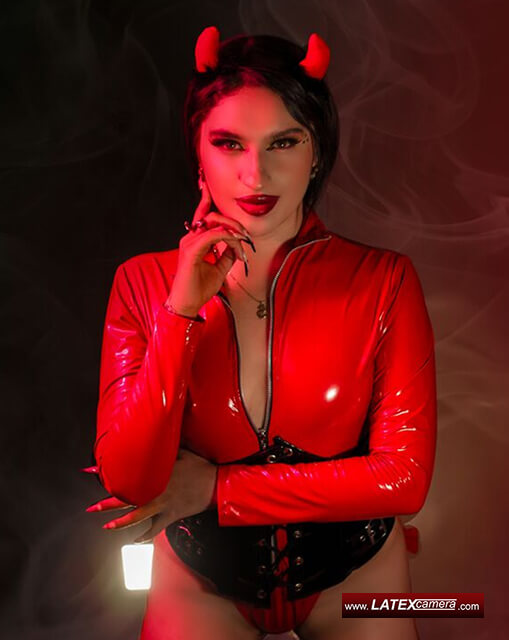 Devilish Domme on latexcamera dressed in red PVC body