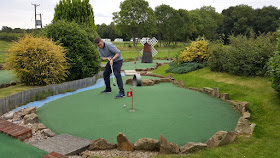 Playing hole 5 of the 11-hole Crazy Golf course at York Golf Range in Towthorpe near Strensall earlier this year. The course was #764 on our travels
