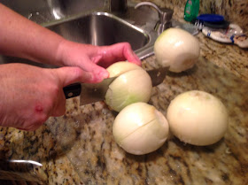 large white round onions being cut in half