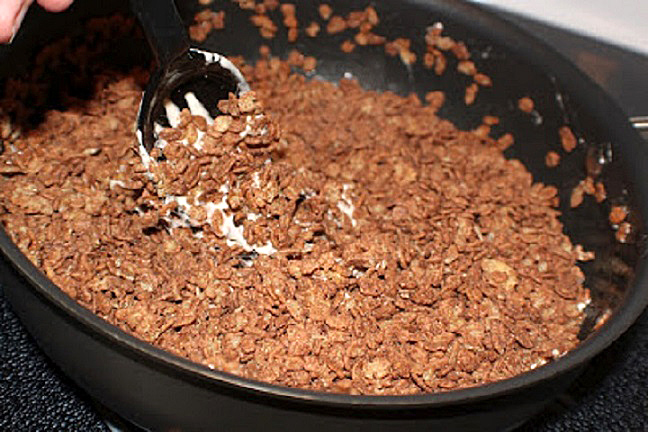 chocolate rice krispies with melted marshmallows in a big pan