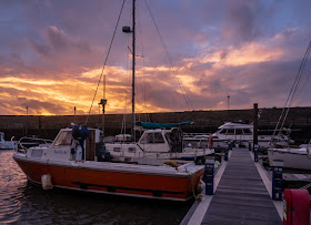 Photo of sunset at Maryport Marina with Ravensdale at the far end of the pontoon