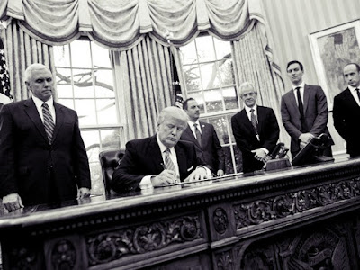 President Donald Trump signs executive orders in the Oval Office.