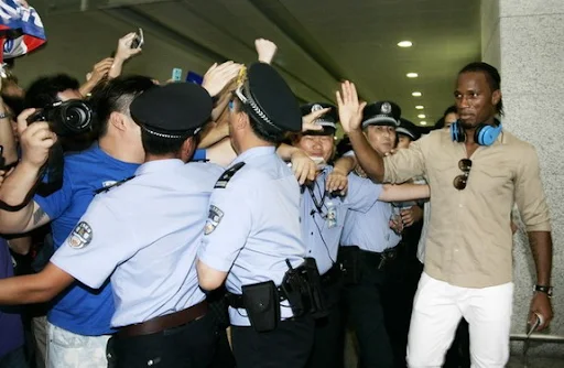 Former Chelsea star Didier Drogba waves to his fans upon his arrival in Shanghai