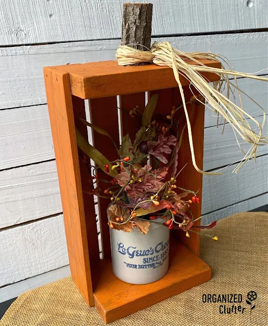 Photo of a DIY pumpkin crate holding fall foliage