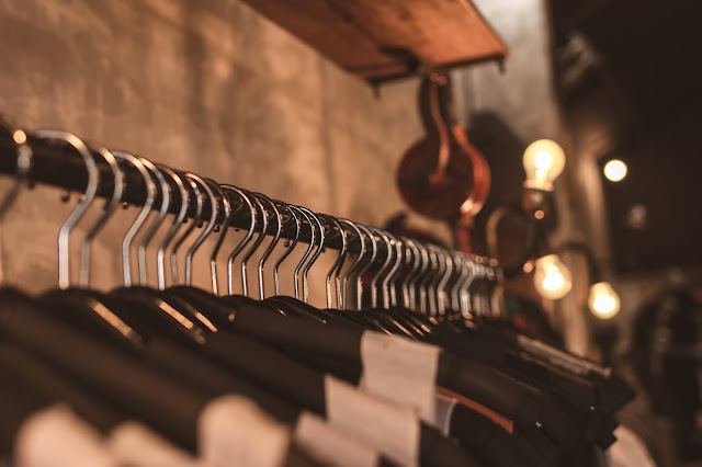 clothes hanging on coat hangers:Photo by Artem Beliaikin from Pexels
