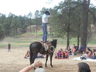 cowboy standing on horse, spinning lasso