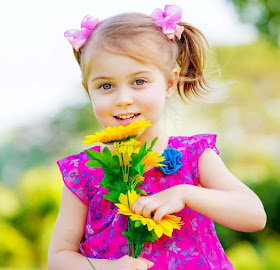 dark-pink-color-frock-wearing-babygirl-standinf-with-flowers