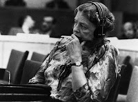 Eleanor Roosevelt sits with headphones during a speech at the United Nations