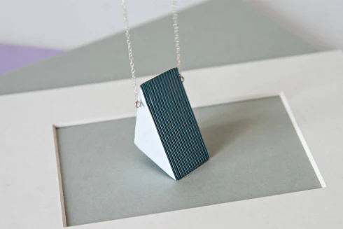 Triangular layered paper pendant necklace in shades of blue and white with silver chain