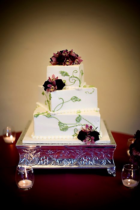 Asian themed square wedding cake with purple ribbon and flower and green