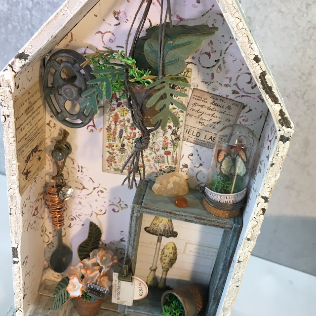 ASW | Tim Holtz Shrine: Shabby Chic Potting Shed Miniature with Speckled Egg and Field Notes details.