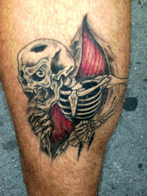ripping skull and skeleton hands tearing through skin tattoo