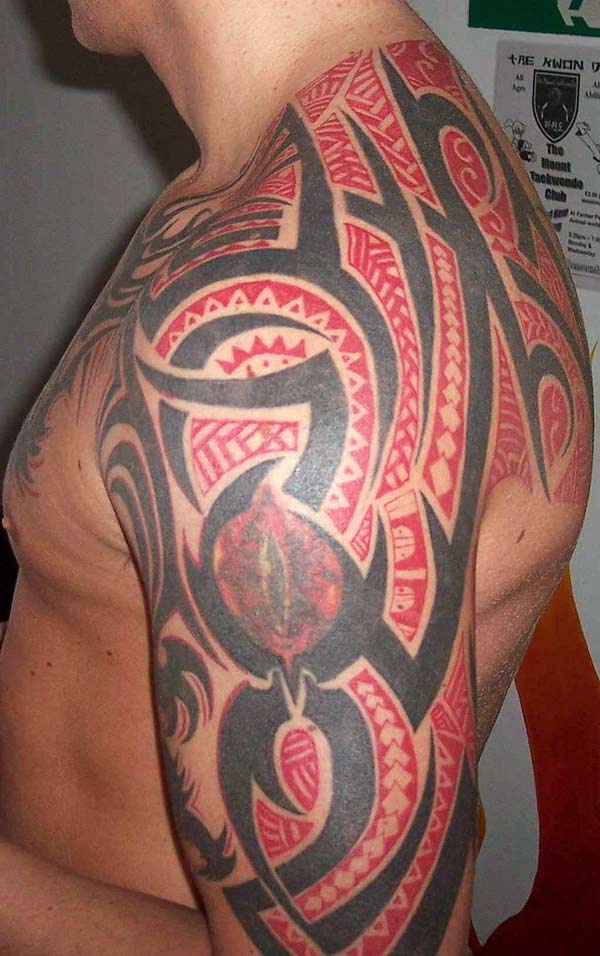 The tribal tattoo on the shoulder and arm tribal with red maori and dark black ink tattoo designs