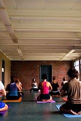 men and women in yoga class